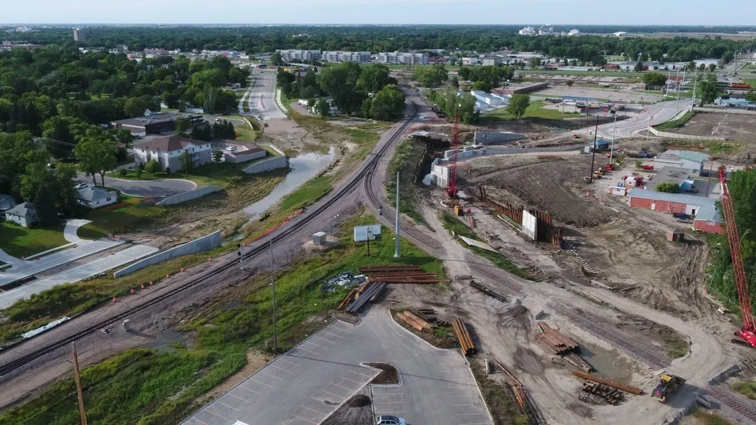 Wide aerial of active construction site with rail and infrastructure