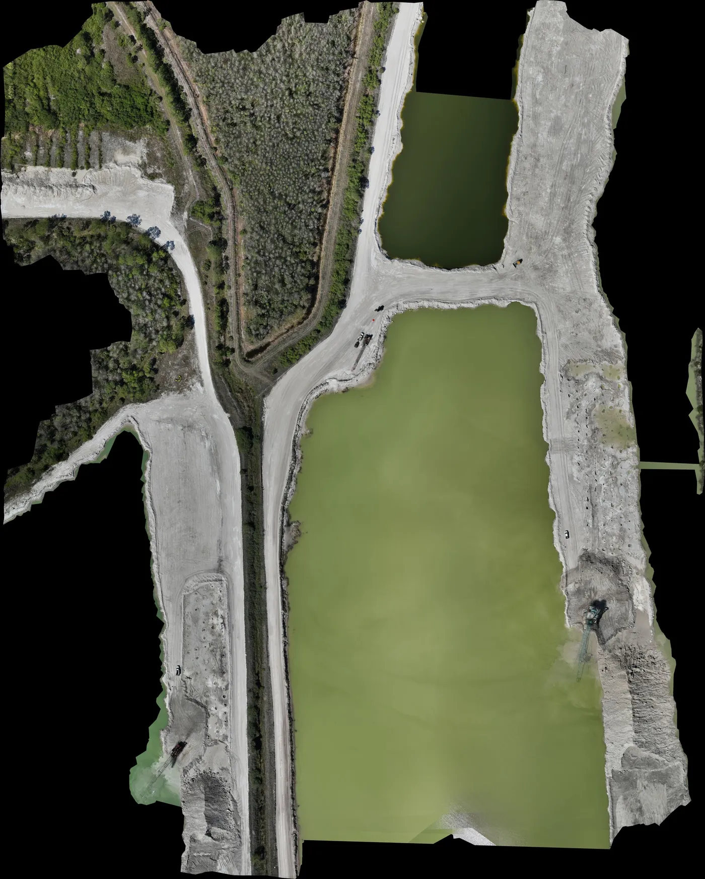 High-resolution drone orthomosaic of an aggregate operation with ponds and stockpiles