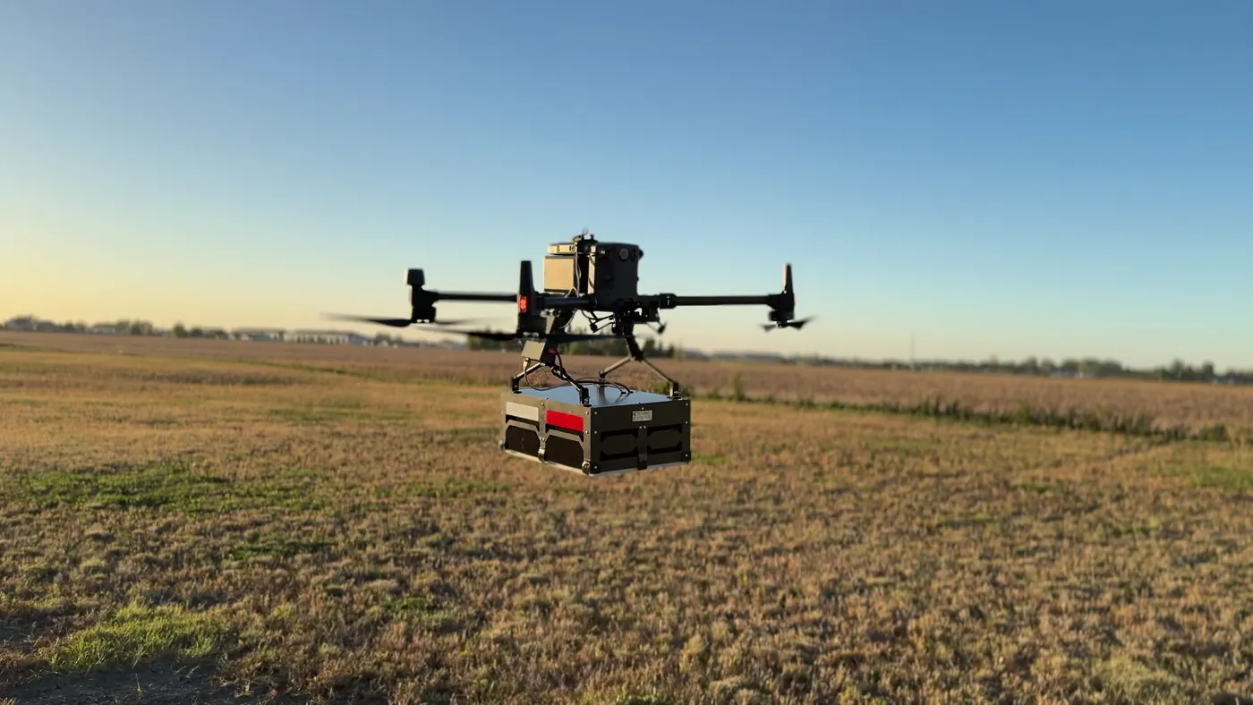 Close view of the Northern Drone airborne GPR platform in flight at golden hour