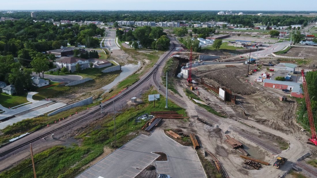 Wide aerial of active construction site with rail and infrastructure